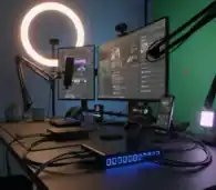 USB hub with multiple ports connected to dual monitors, microphone, and gaming accessories in a professional gaming setup.